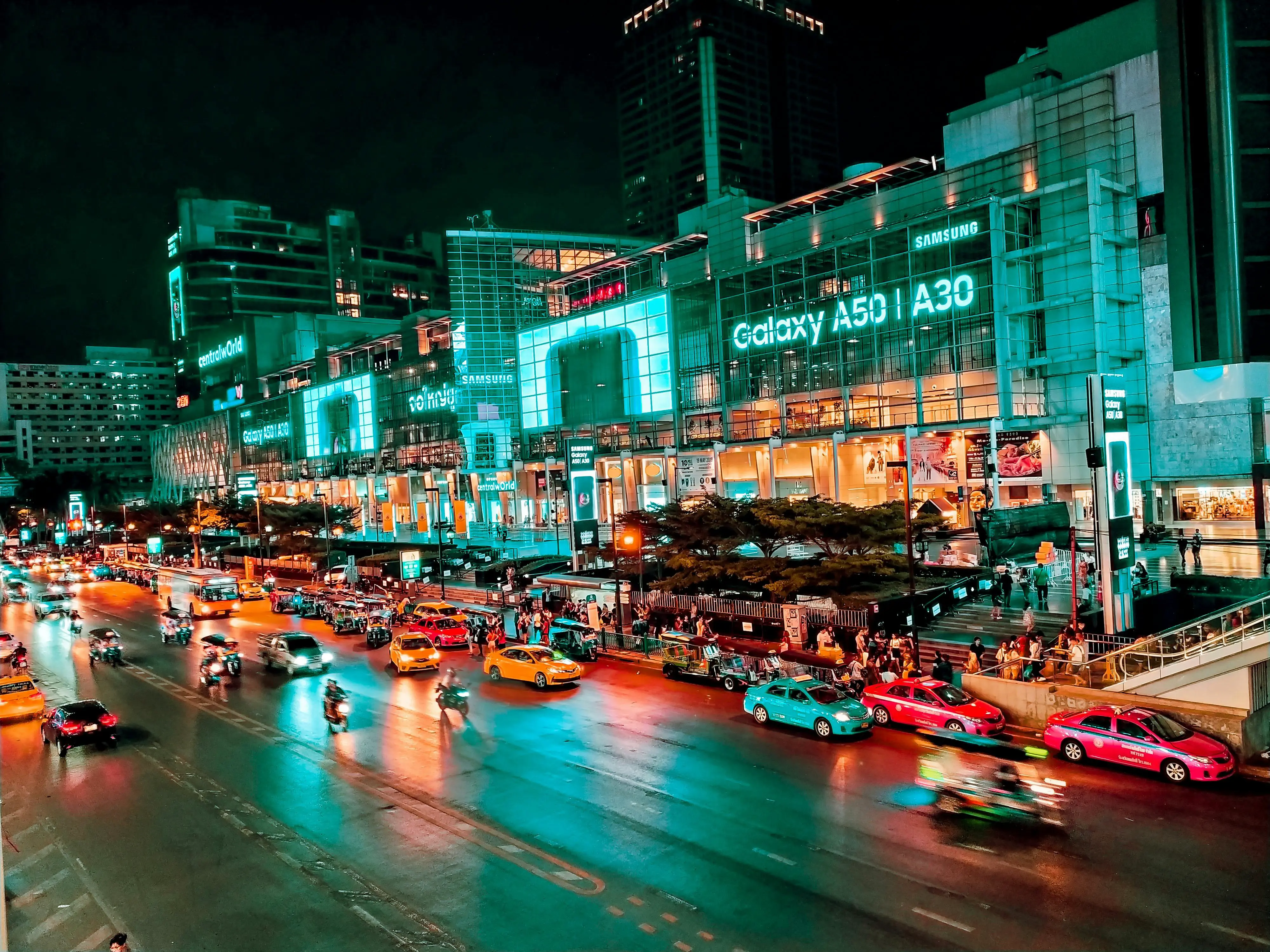 Downtown Bangkok with vibrant city lights and busy streets.
